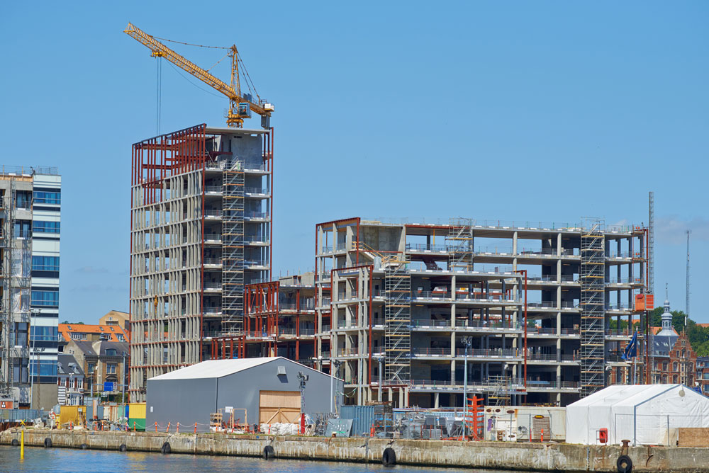 Multi-story building under construction with crane.