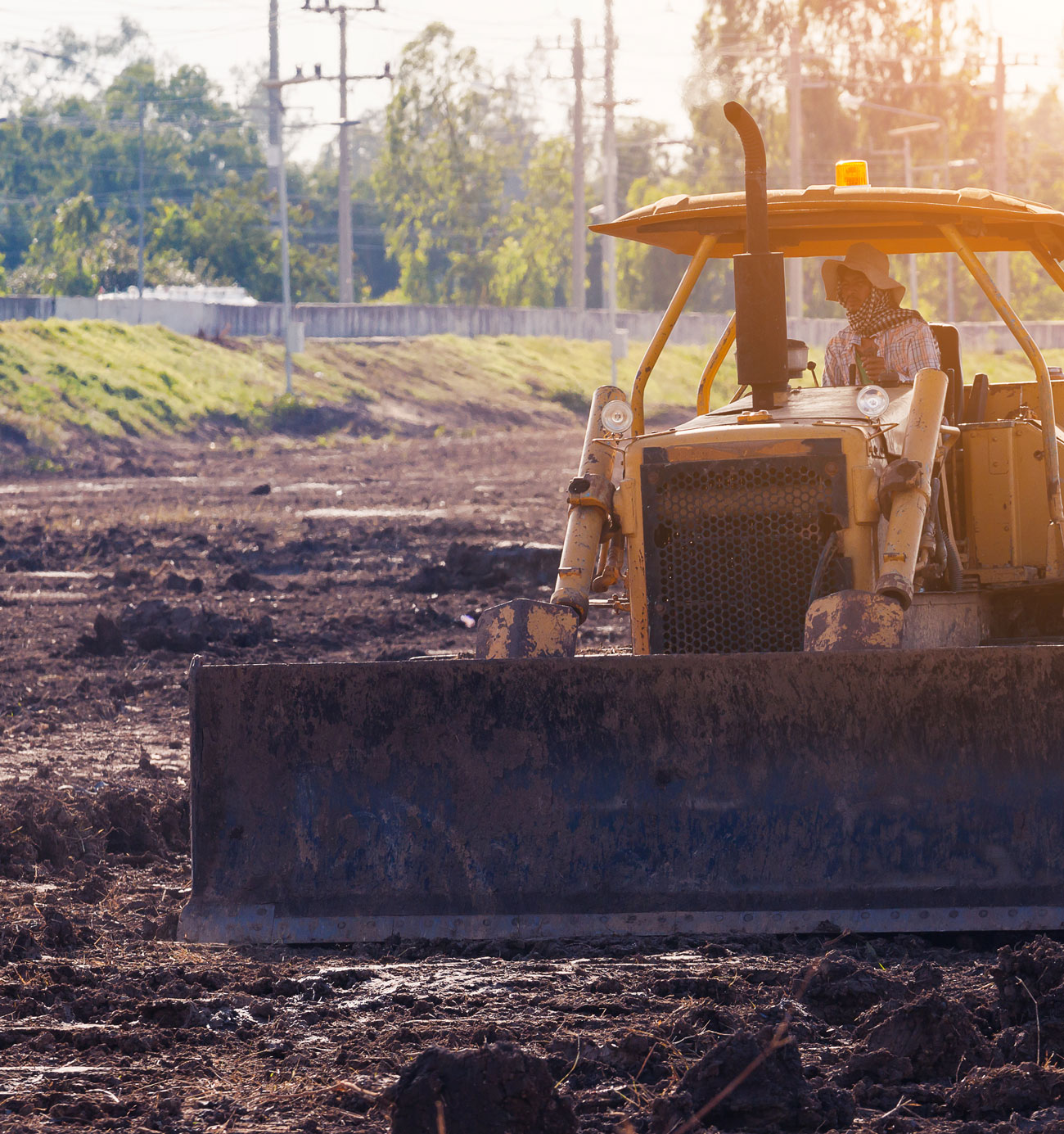Bulldozer moving dirt at construction site.