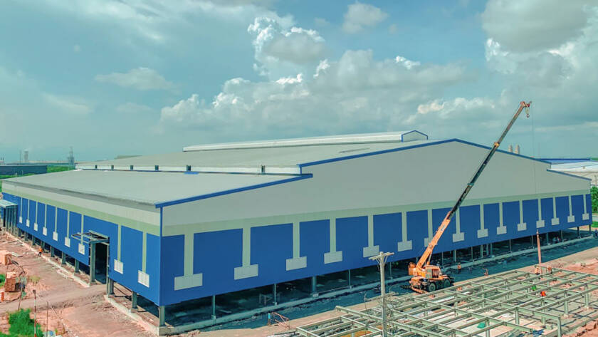 Blue commercial metal building under construction.