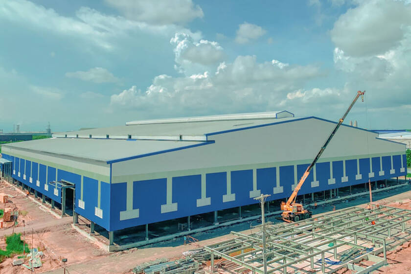 Blue commercial metal building under construction.