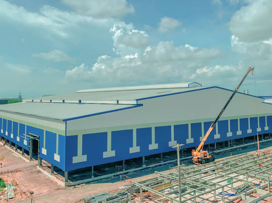 Blue commercial metal building under construction.